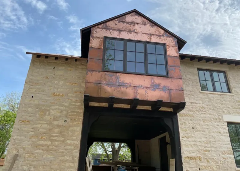 Copper metal panel facade on a stone building for Metal Roof Coating in Spring Grove